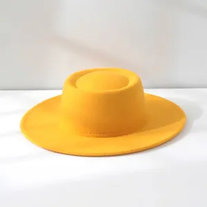 Close-up detail of a bright yellow retro French style wool felt flat top hat