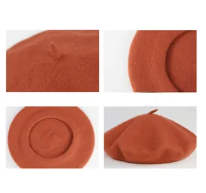Macro view of an orange wool beret showcasing the soft felt texture and top stalk detail