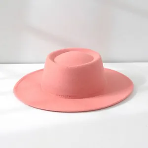 Detail of a retro French pink wool felt flat top boater hat for women