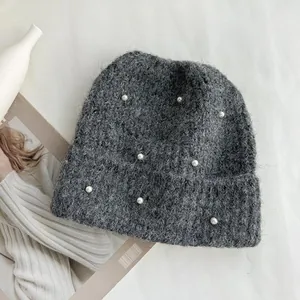 Grey winter knitted beanie with sweet pearl decorations for warmth and stylish comfort