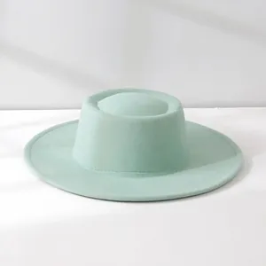 Elegant mint green wool felt boater hat with a minimalist retro French design for women.