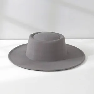 Classic grey woolen wide-brim jazz hat with flat top design in a soft studio light.