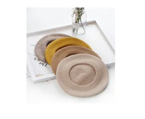 Selection of vintage wool beret hats in warm beige, tan, mustard and brown shades.