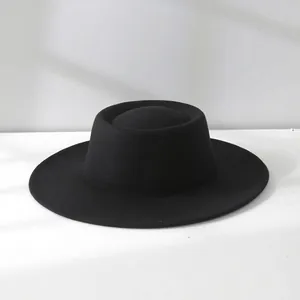 Detailed view of a vintage French black wool boater hat with a structured flat top.
