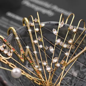 Trending gold wrap-around ear cuffs set with sparkling zircons and a lightning bolt design