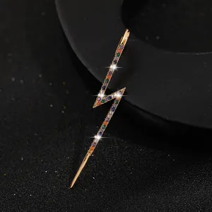 Golden lightning ear crawler earring with multi-colored sparkling zircons on black background