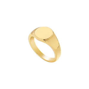 Detail shot of a minimalist gold-colored alloy signet ring with circular flat top