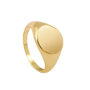 Minimalist polished gold signet ring featuring a wide band and round flat top face.