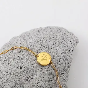 Detailed macro view of 18K gold plated Sagittarius constellation bracelet on stone.