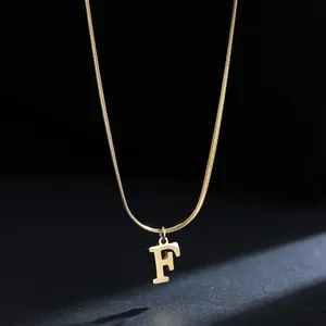 Detail view of 18K gold-plated stainless steel snake chain with letter F pendant.
