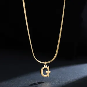 Detail view showing a 18K gold plated stainless steel initial G pendant on snake chain