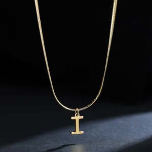 Detail shot of a minimalist 18K gold plated stainless steel necklace with I pendant
