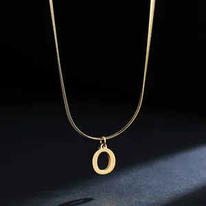 Close-up of a minimalist 18K gold-plated stainless steel letter O pendant necklace