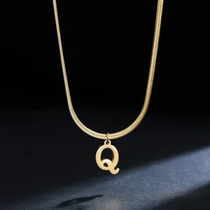 Macro detail of a gold 18K plated stainless steel necklace with initial Q pendant