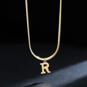 Detail of gold-plated stainless steel necklace featuring a polished capital letter R