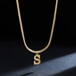 Close-up of golden stainless steel snake chain necklace with an initial S pendant