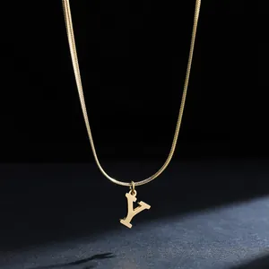 Detailed macro view of gold letter Y pendant on sleek stainless steel snake chain