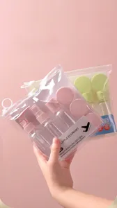 Portable travel bottle set for skincare and toiletries in clear pink zipper pouch.