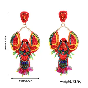 Detailed view of handmade beaded lobster earrings showing 97mm height and total weight