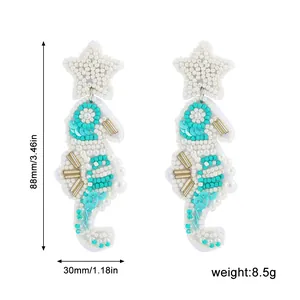 Close-up of handmade beaded seahorse earrings showing 88mm length and 8.5g weight