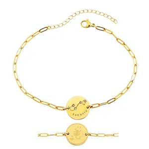 Detailed close-up of 18K gold plated Scorpio zodiac bracelet with paperclip chain