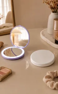 Compact folding LED makeup mirror showing open and closed states on a vanity