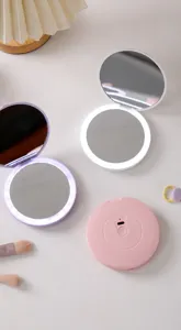Portable LED folding makeup mirror with adjustable brightness and USB-C charging