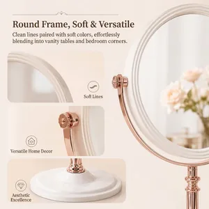 Vintage rose gold rotatable round makeup mirror with an elegant white pedestal base