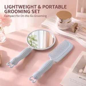 Portable light blue handheld mirror and comb set with cute character design handles.