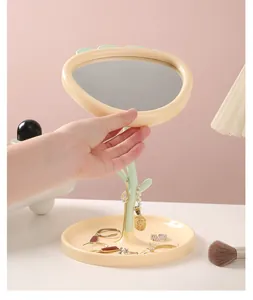 Detailed view of a cute strawberry flower makeup mirror with jewelry storage base