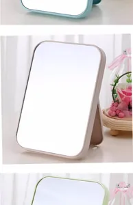 Detail view showing the sleek folding design and pastel colors of the vanity mirror