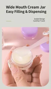Detail view of a portable wide-mouth cream jar with a spatula for travel skincare.