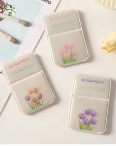 Macro view of portable folding makeup mirrors featuring elegant tulip designs and slogans