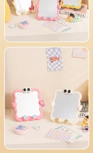 Detailed view of cute pink and white wavy desktop makeup mirrors with cartoon eyes