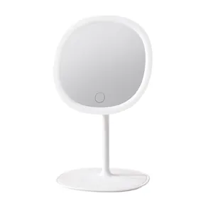 Minimalist white LED desktop makeup mirror with touch sensor and circular light ring.