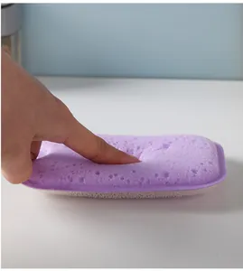 Detailed close-up of soft purple cleaning sponge showing its texture and elasticity