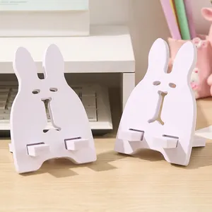 Supporto bianco per telefono e tablet a forma di coniglio per una scrivania ordinata