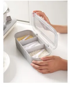 Detail view of a 3-compartment seasoning box with spoons and transparent lid.