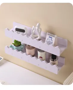Close-up view of two white wall shelves with decorative wave edges and small props