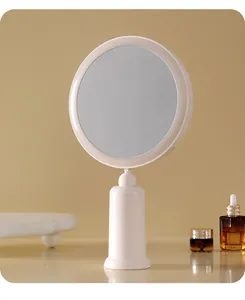 Close-up detail of a minimalist white desktop LED makeup mirror in a cozy setting
