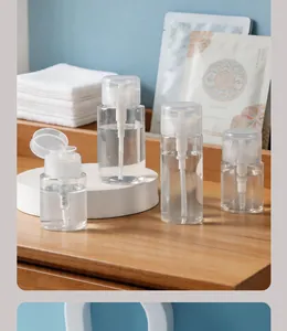 Close-up of clear travel pump bottles set arranged on a natural wooden bathroom counter