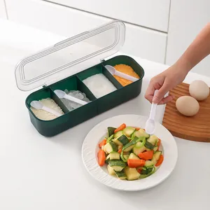 Four-compartment green seasoning box with spoons and clear lid for kitchen organization