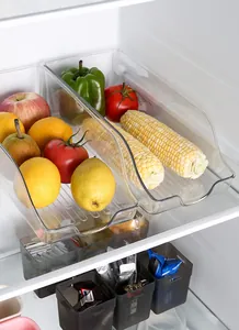 Detailed view of transparent slanted-mouth refrigerator bins filled with fresh produce