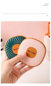 Close-up of portable square textured compact mirror with engraved love day text