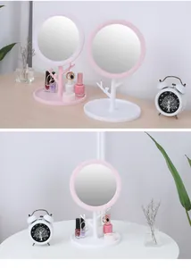 Detailed view of branch-style makeup mirror with jewelry tray and pink frame