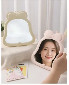 Aesthetic bow-knot desktop makeup mirrors shown in cream and pink colors for vanity