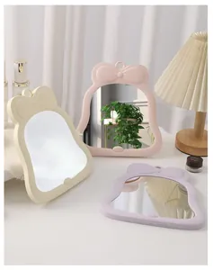Set of three cute bow-knot desktop makeup mirrors in cream, pink, and light purple tones
