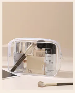 Borsa da viaggio in PVC trasparente con cerniera bianca e vari prodotti per il trucco