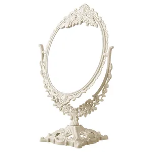 Specchio da trucco ovale in stile europeo vintage con intagli floreali e base girevole.