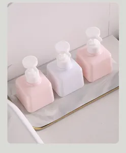 Set of three square refillable pump bottles in pink and white for lotions and soaps